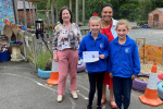 Pauline pictured with pupils and the Headteacher of St Andrew's CofE Primary School